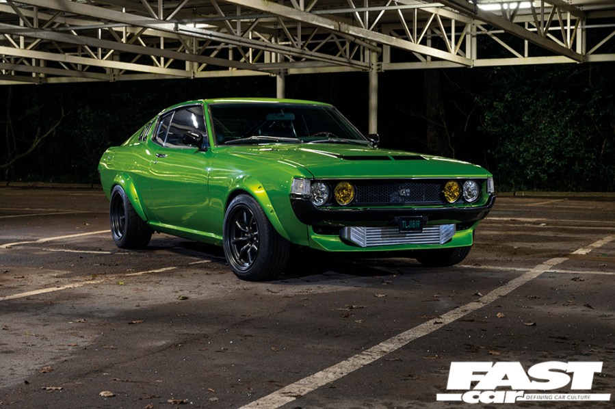A front right side shot of a green Toyota Celica Mk1