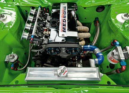An aerial view of the throttle bodies in a bright green car