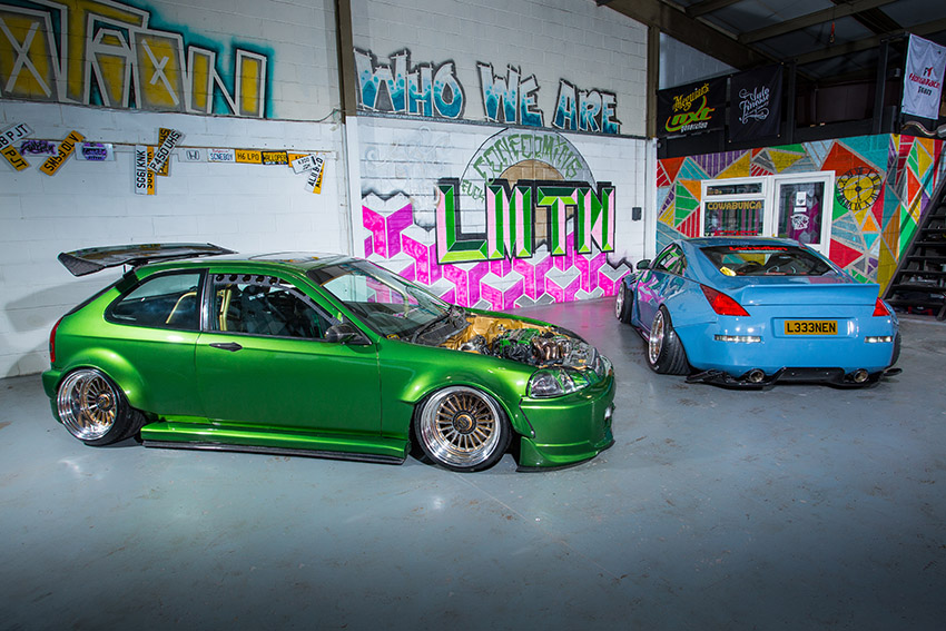 Two immaculate stanced cars in a garage, which are likely to have needed chassis work.