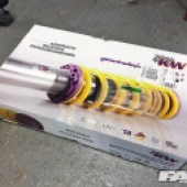A box containing KW coilovers.