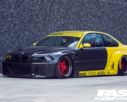A left side shot of a black and yellow Kean BMW M3