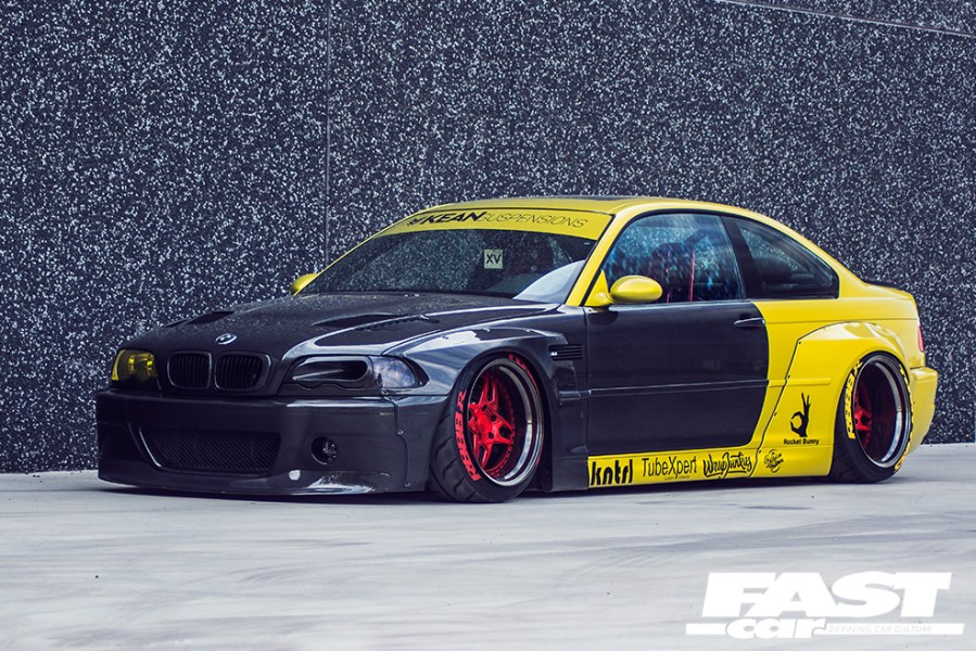 A left side shot of a black and yellow Kean BMW M3