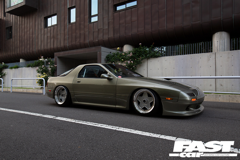 Right side view of a murky green tuned Mazda RX 7 FC Japan
