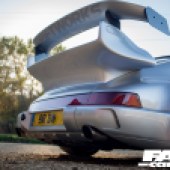 A up looking shot of the rear of a silver Porsche 964