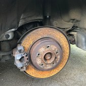 old brake rotors and pads on a BMW