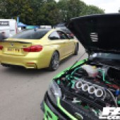 Gold BMW driving past a green Ford engine at the Forge Action Day 2019
