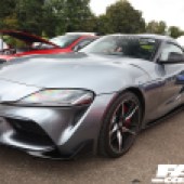 Close front left shot of a shiny dark grey Toyota Supra at the Forge Action Day 2019