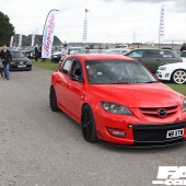 A red and black Mazda Speed 3 driving at the Forge Action Day 2019
