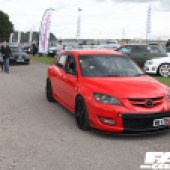 A red and black Mazda Speed 3 driving at the Forge Action Day 2019