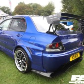 Left rear shot of a blue Mitsubishi Lancer Evolution with a black spoiler at the Forge Action Day 2019