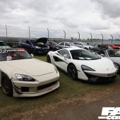 Two rows of cars parked near the track fence at the Forge Action Day 2019