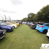 Two rows of cars along the track fence at the Forge Action Day 2019
