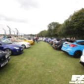 Two rows of cars along the track fence at the Forge Action Day 2019