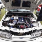 The blue red and silver engine of a white Ford Sierra at the Forge Action Day 2019
