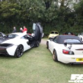 A black and white McLaren 540C next to a white Honda S2000 at the Forge Action Day 2019