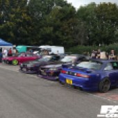 A row of blue, purple and pink cars next to a blue gazebo at the Forge Action Day 2019