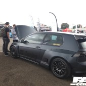 The left side of a matte black VW Golf R with the bonnet open at the Forge Action Day 2019