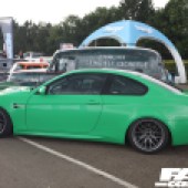 Left side view of a bright green BMW M3 GT2 with a spoiler at the Forge Action Day 2019