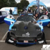 Central front view of a black and blue Mazda RX 7 with the doors open at the Forge Action Day 2019