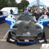Central front view of a black and blue Mazda RX 7 at the Forge Action Day 2019