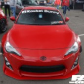 A central front view of a red Toyota 86 at the Forge Action Day 2019