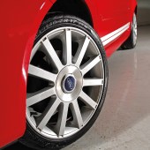 A low shot of the front left wheel of a red Ford Fiesta ST Mk6
