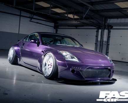 A front right side shot of a purple 5th generation Nissan Z-Car in an empty garage