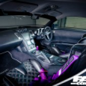 A shot across the front seats of a black and purple 5th generation Nissan Z-Car