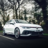 A close up moving front right shot of a white VW Golf GTI Clubsport Mk8