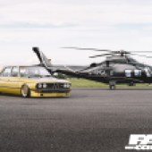 Modified yellow BMW E12 with a helicopter