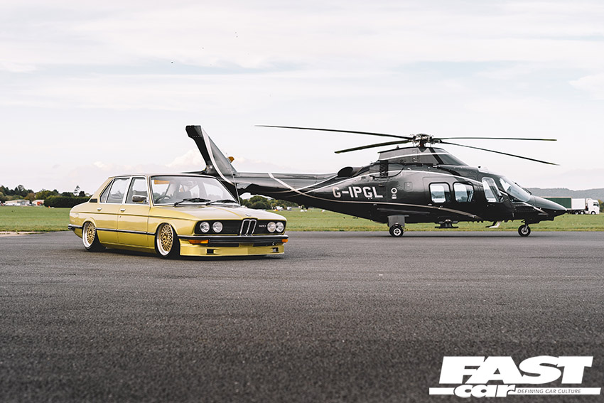 Modified yellow BMW E12 with a helicopter