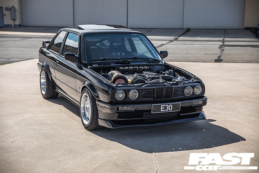 Modified BMW E30 Turbo with bonnet off showing engine