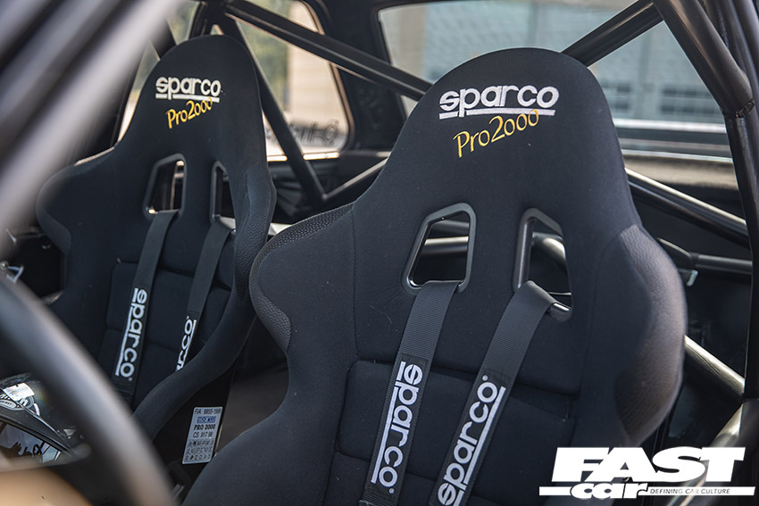 Sparco bucket seats inside of modified bmw e30 turbo