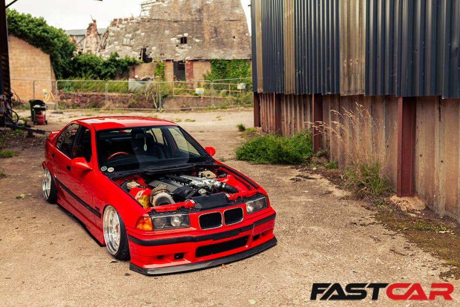 front 3/4 shot of modified bmw e36 with bonnet off