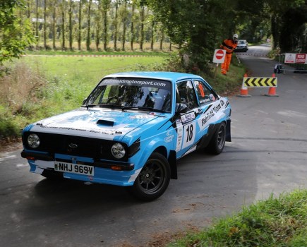 A Mk2 Ford Escort rallying on a closed course.