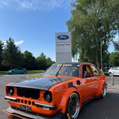 Modified Ford Escort Mexico outside Ford sign