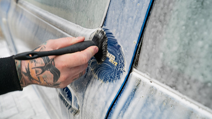 Soft brushes can help clean dirt away from badges