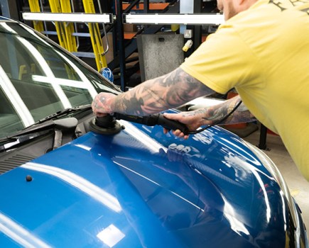Waxing the bonnet on a Clio car