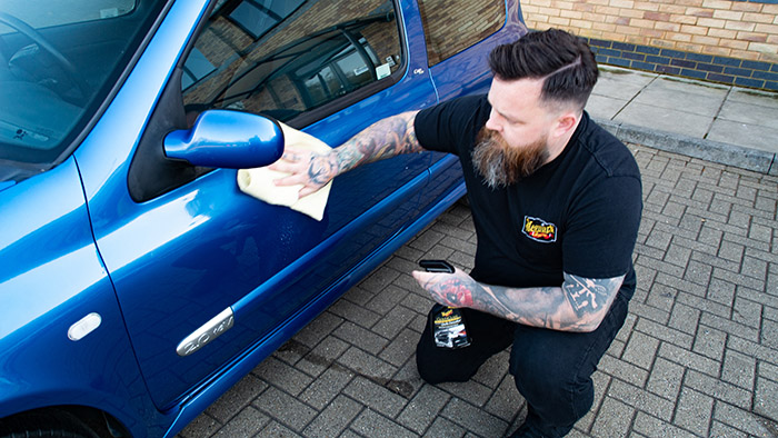Apply quick detailer to renault clio during maintenance wash