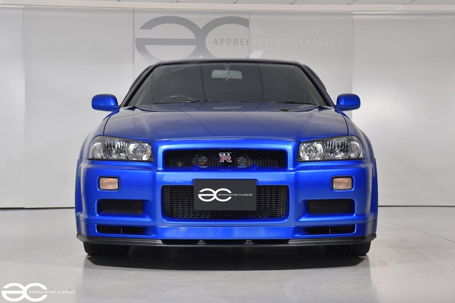 The front end of a Bayside Blue R34 GT-R.