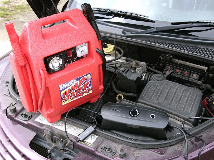 CTEK CSFree Battery Charger resting in a car's engine bay.