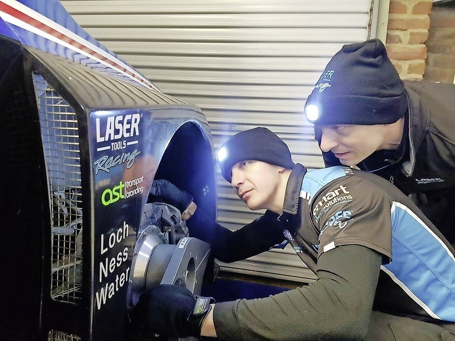 Mechanics with Laser beanie hats inspecting Aiden Moffat's BTCC racecar.