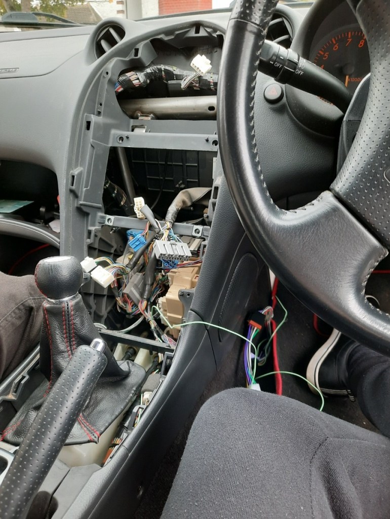 Exposed wiring for a car stereo.