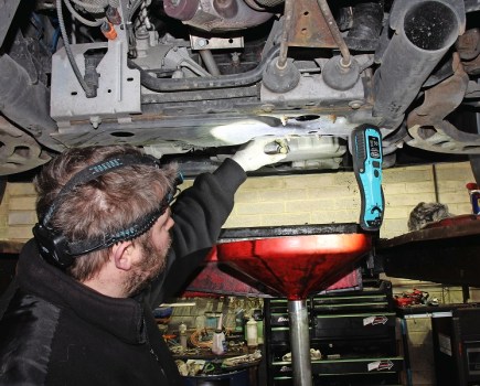 Headtorch/inspection lamp being used under a car.