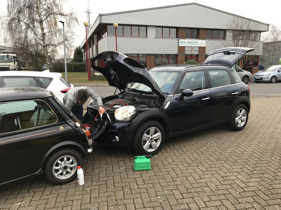 A Countryman being used to jump start an old Mini
