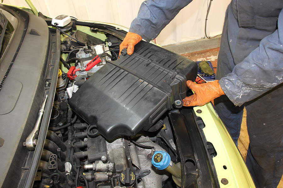 removing air filter housing on a car 