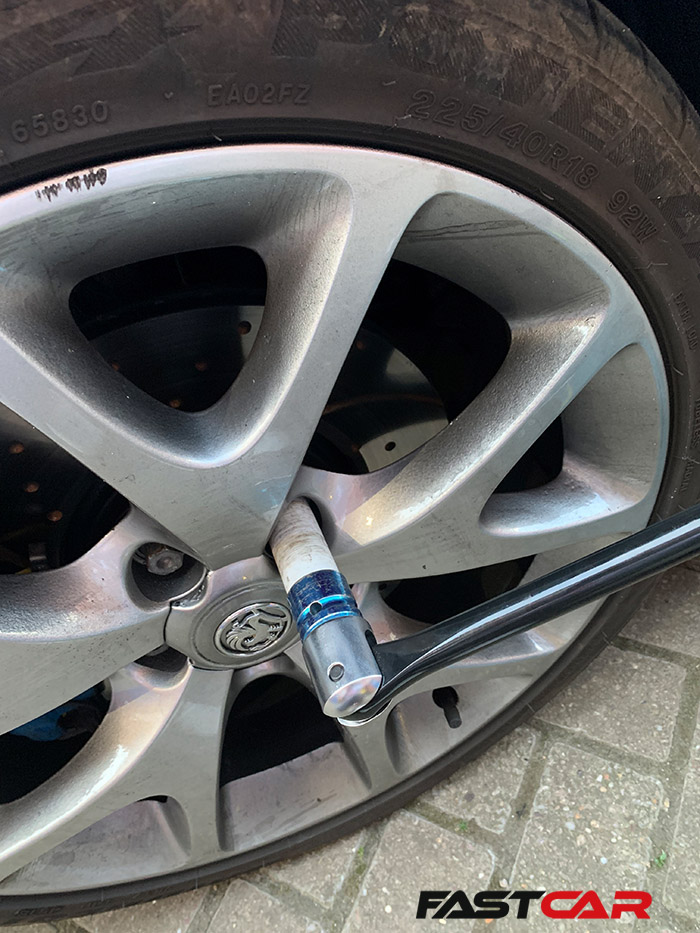 Torque wrench loosening nuts on alloy wheels