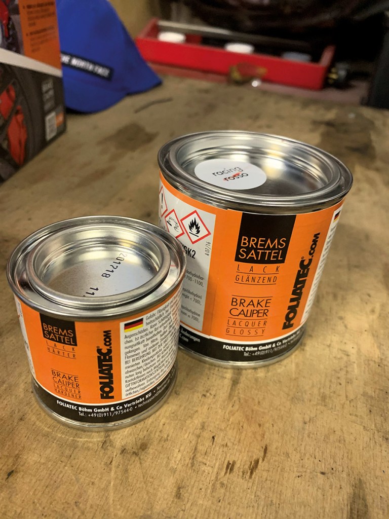 The two paint pots in a brake caliper paint kit