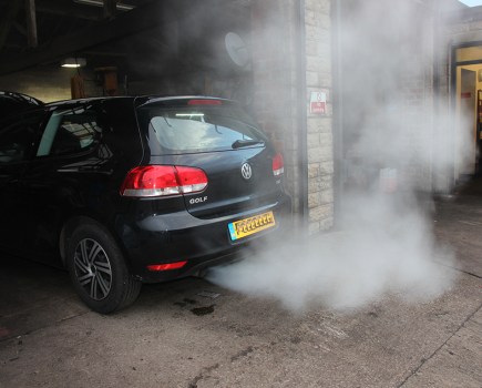 Car exhaust smoke on golf