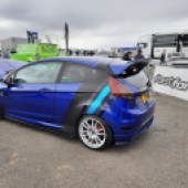 blue Fiesta next to Fast Ford banner
